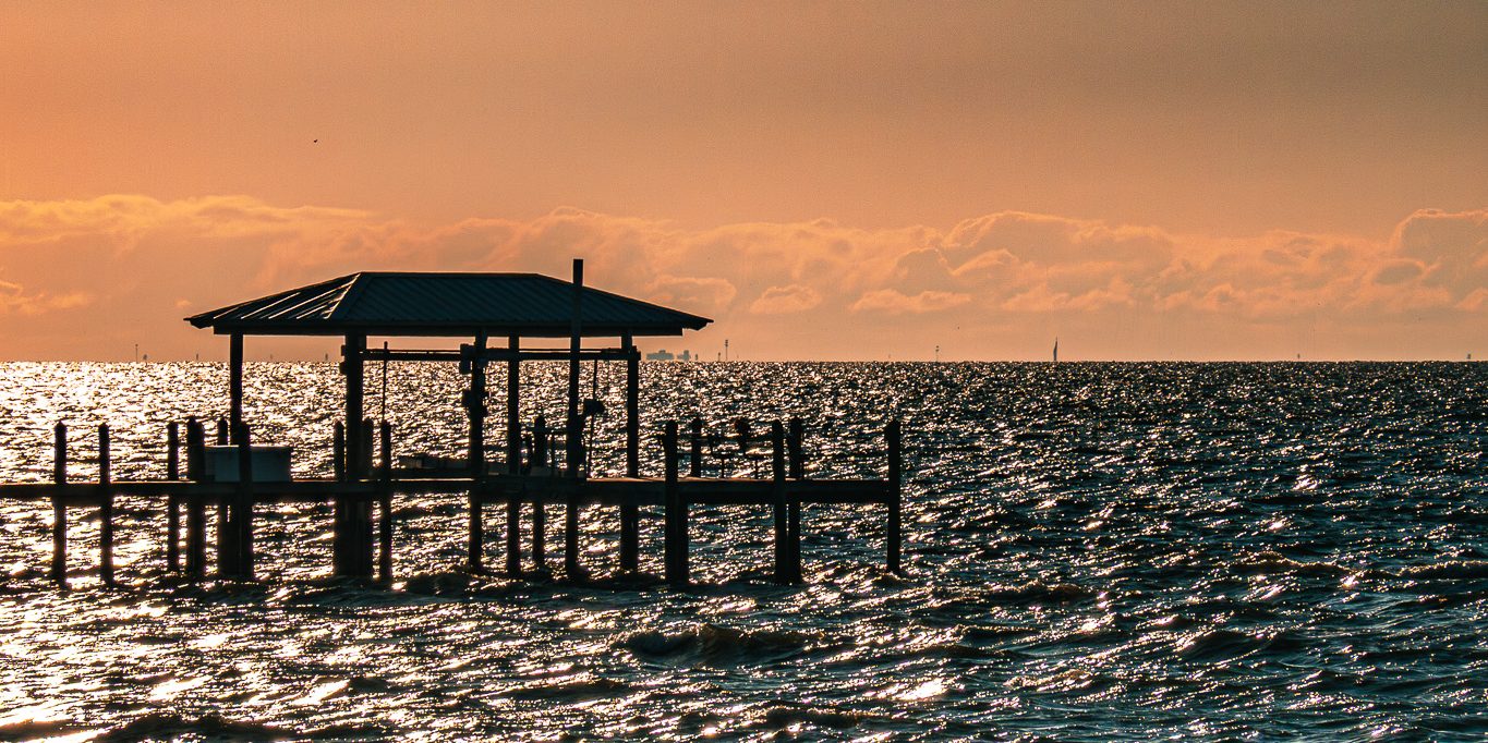 A covered dock on Tampa Bay at sunset, photographed at the Apollo Beach Nature Preserve