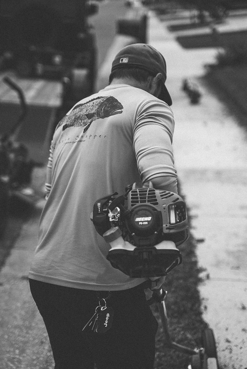 Black and white frame of a leaf blower in use, SouthShore LawnLife