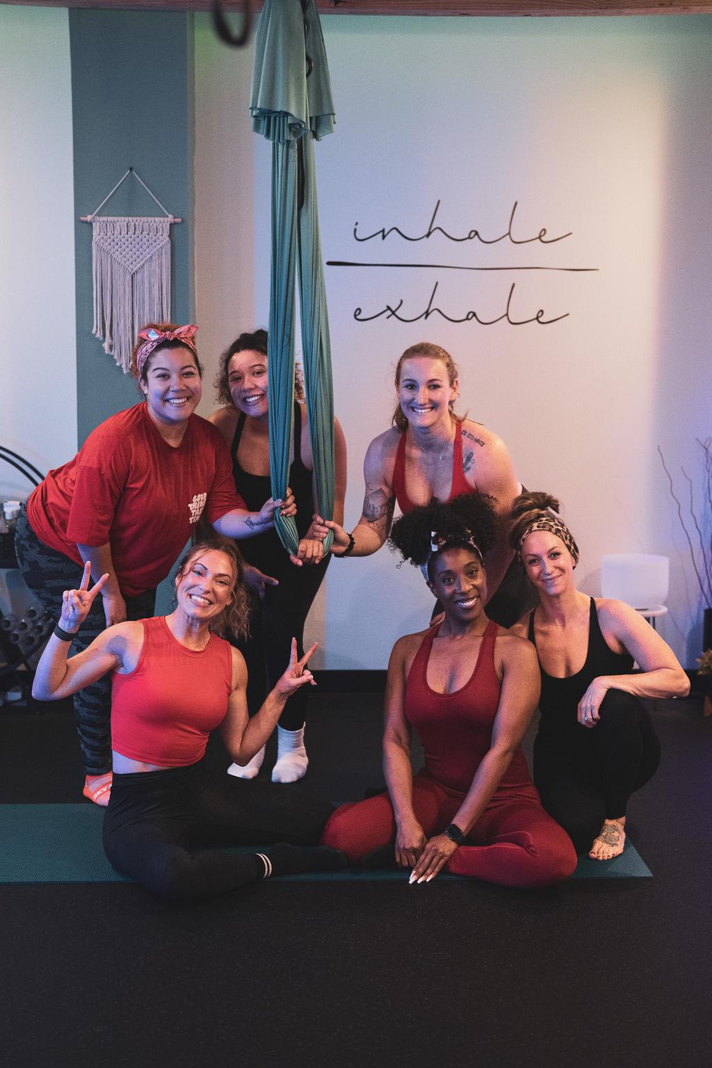 Six members of the aerial class smiling together beside a hammock