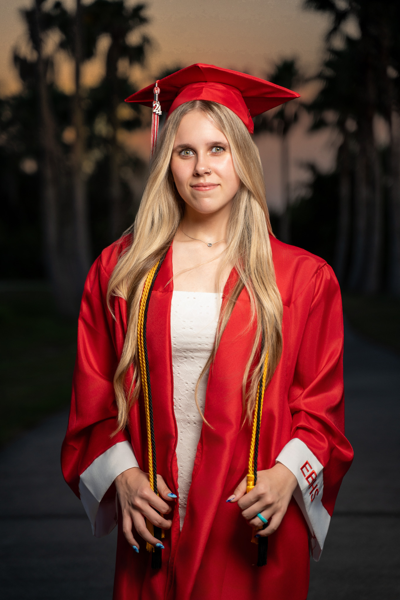 Graduate in cap and gown, studio portrait