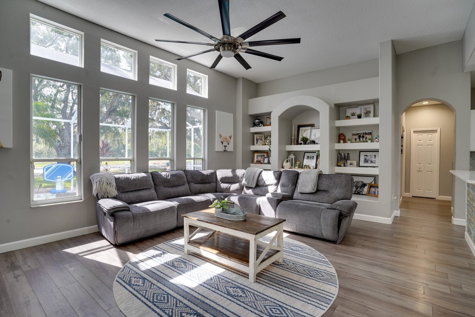 Bright living room with tall windows and built-in shelving