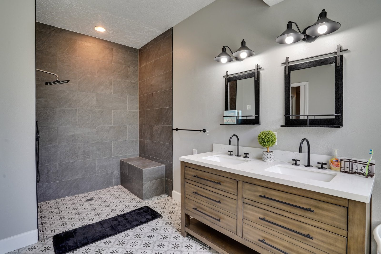 Primary bathroom with tile shower and double vanity