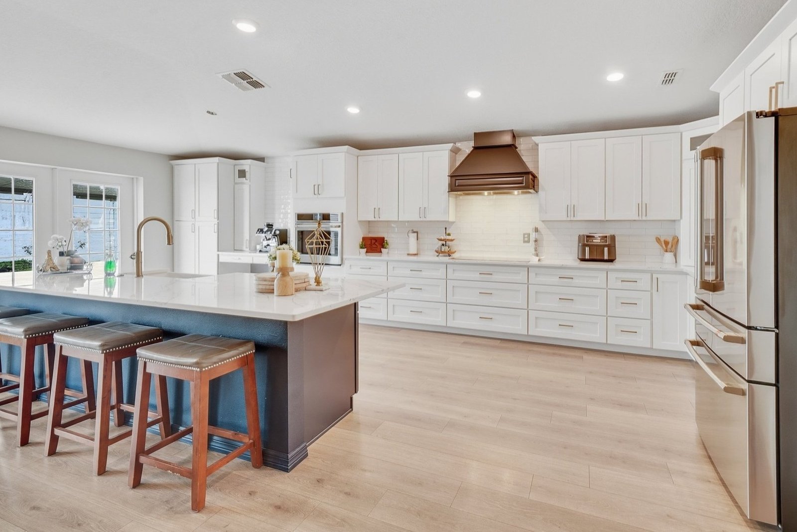 Modern kitchen with bronze range hood and quartz countertops