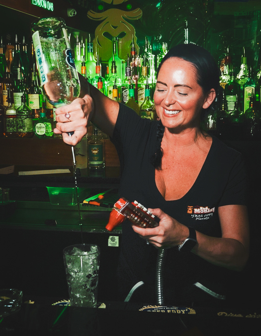 Bartender mixing a green cocktail at Bad Monkey